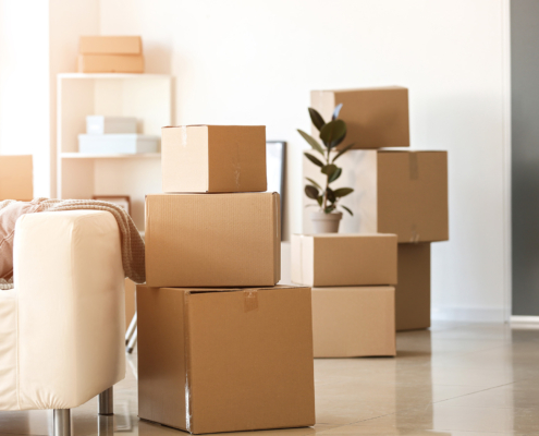 Moving boxes with belongings in room