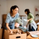 Person packing belongings into cardboard boxes