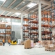 Warehouse workers managing logistics with forklifts and packages