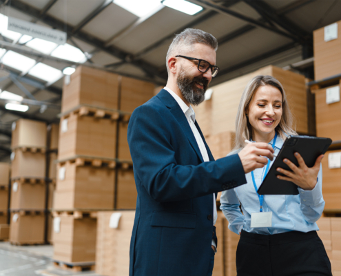 workers in warehouse on tablet