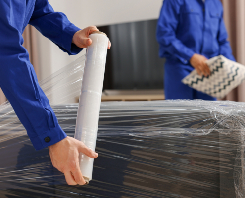 Two workers preparing furniture for move