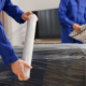 Two workers preparing furniture for move
